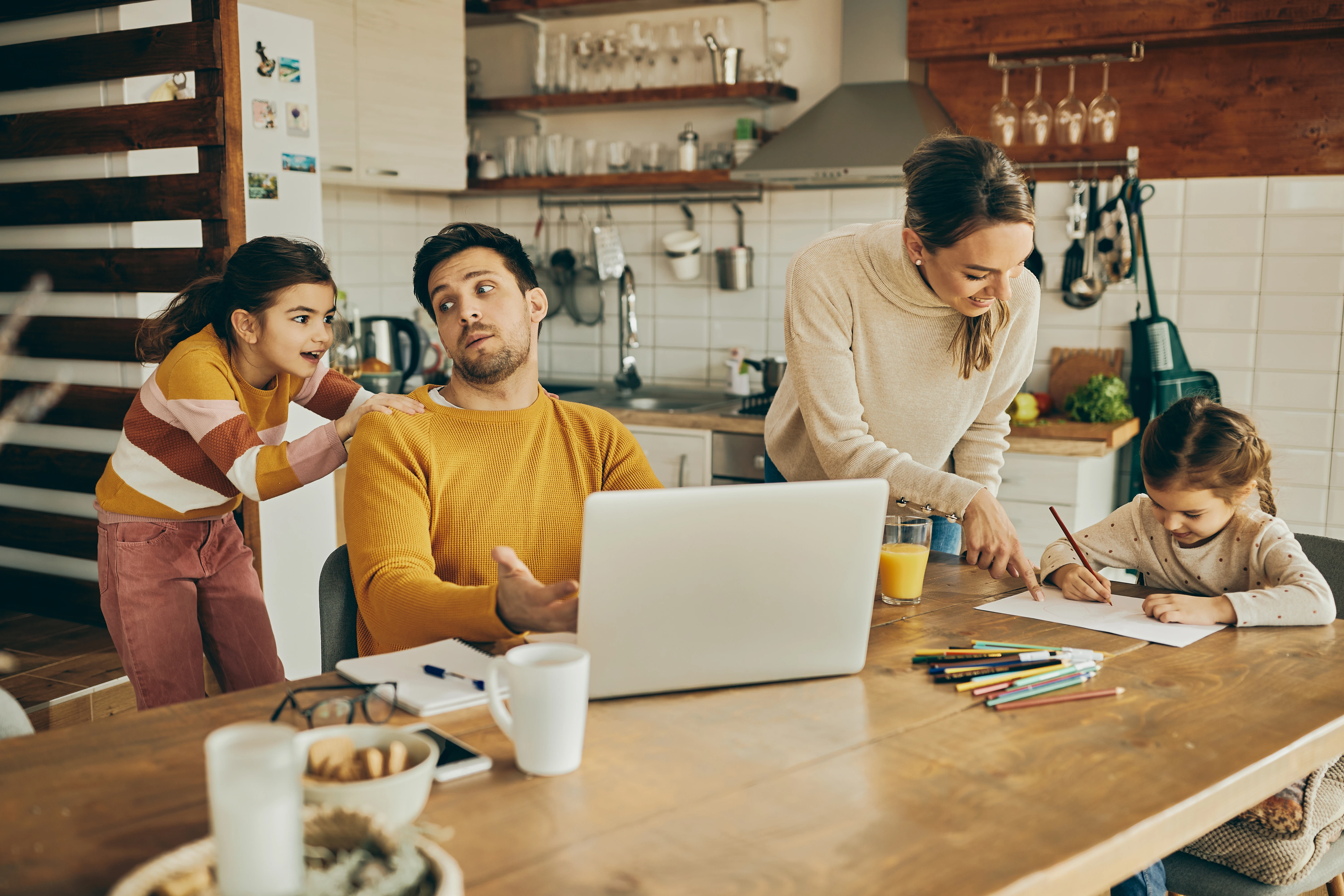 Australian family reviewing second home finances at kitchen table